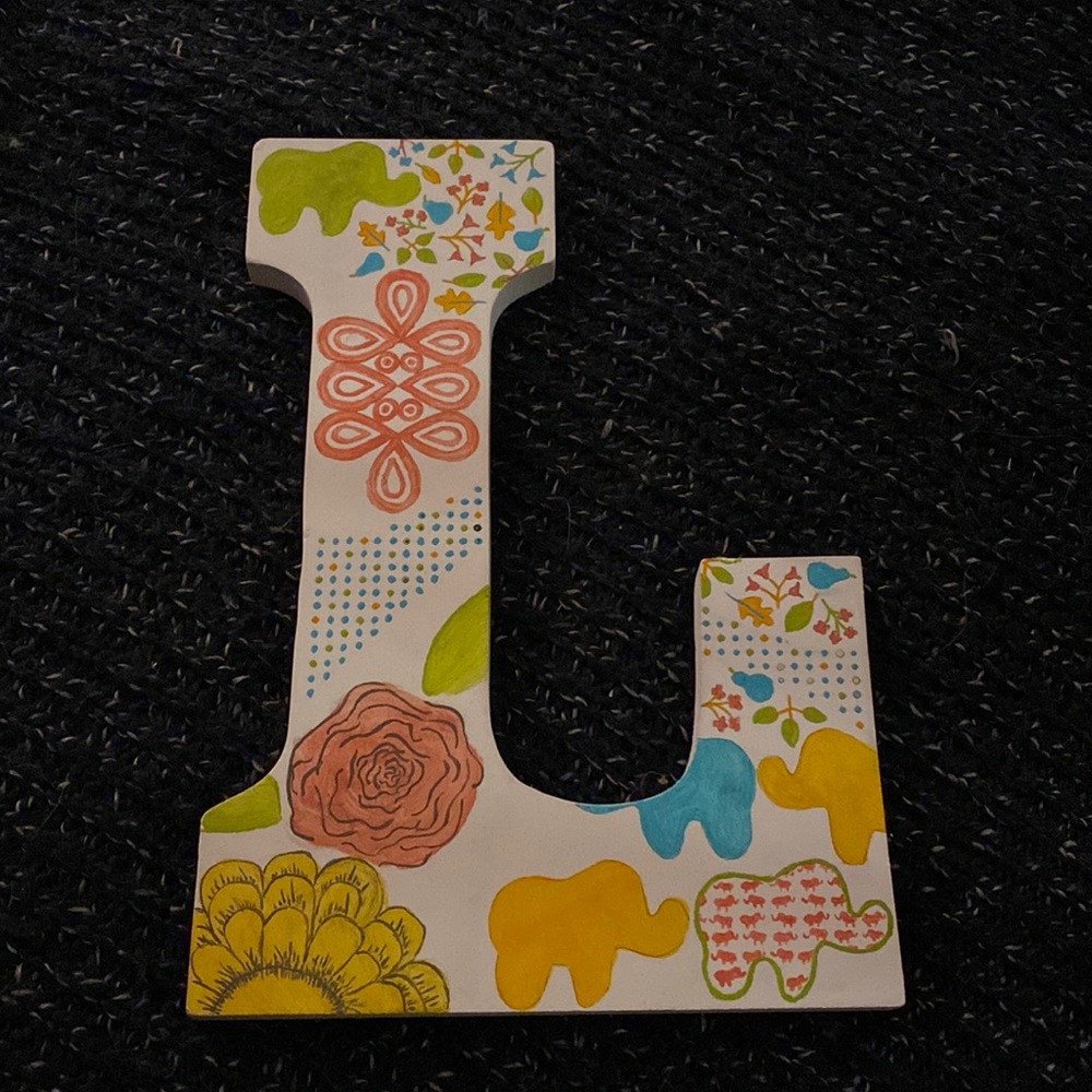 Letter L with elephant and flower design